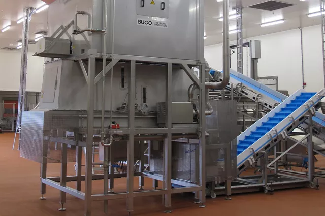 This image shows an industrial ice machine in operation. This image shows an industrial ice machine in operation.
